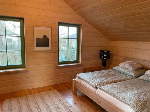 a bedroom with a bed in a log cabin at Dom Galicja in Radziechowy