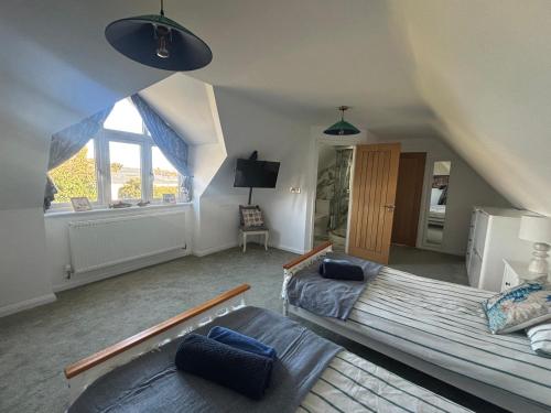 a attic room with two beds and a couch at Seaview in Lowestoft