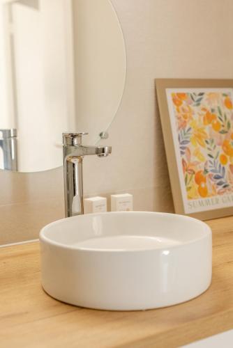 a bathroom sink with a faucet on a counter at Les Mimosas in Ronce-les-Bains