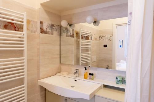 a bathroom with a sink and a mirror at Casa Julia - Menaggio by LoveComo in Menaggio