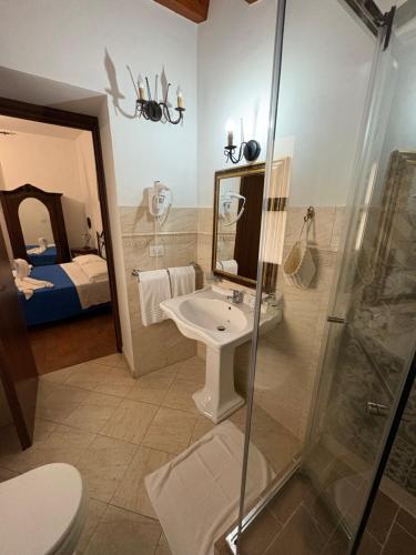 a bathroom with a sink and a shower at B&B Mirabella Rooms Ortigia in Syracuse