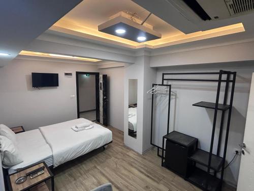 a bedroom with a bed and a tv in it at Avist Hotel Avcılar in Avcılar