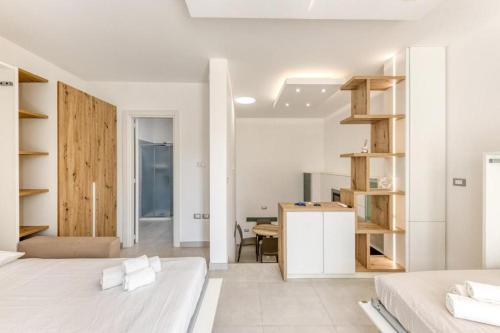 a bedroom with two beds and a desk in a room at La Spiaggetta 2 in Torre San Giovanni Ugento
