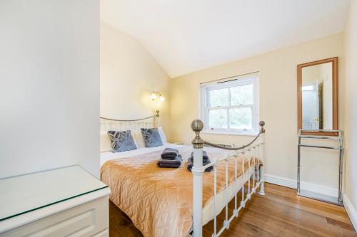 a bedroom with a bed with a dresser and a mirror at The Retreat with Free Parking in Ambleside