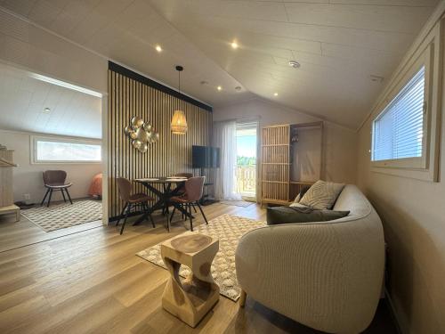 a living room with a couch and a table at Riihen Ullakko in Äkäslompolo