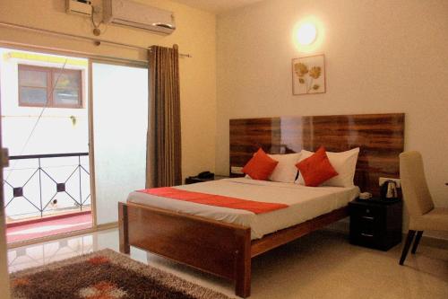a bedroom with a bed and a large window at SAS Apartment in Bangalore