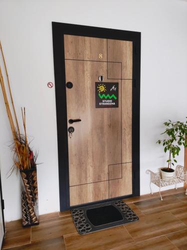 a door with a sign on it in a room at Студио Странджа - Граматиково in Gramatikovo