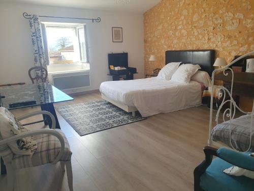 a bedroom with a large bed and a mirror at Gîte à la campagne "Le Luquet" in Chazelles