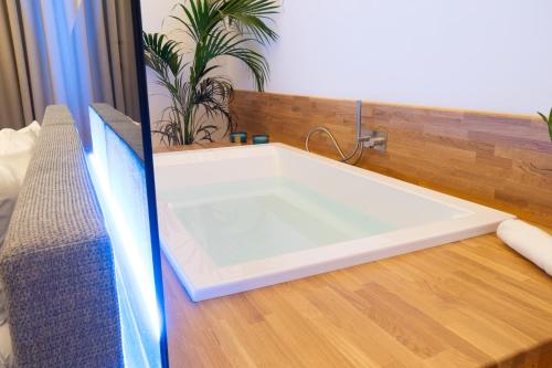 a white bath tub sitting on top of a wooden floor at Cala Bianca in Trani