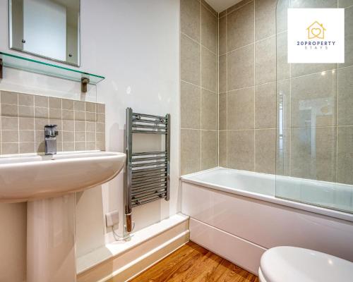 a bathroom with a sink and a toilet and a tub at Contractors and Relocations Haven with Parking in Basingstoke