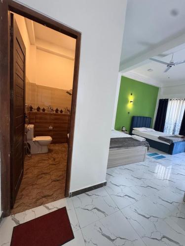 a room with a bathroom with a toilet and a tub at Muthugala Resort in Anuradhapura
