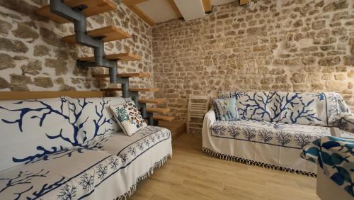 a living room with a couch and a brick wall at Casa Blu in Šibenik