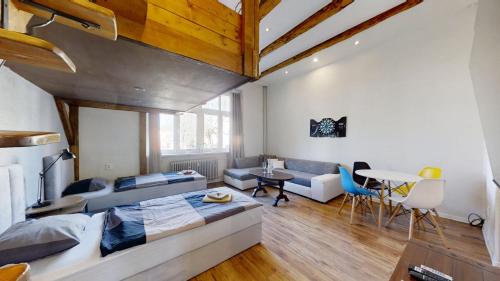 a bedroom with a bed and a living room at Old Town Loft in Žilina