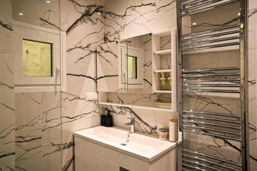 a bathroom with a sink and a mirror at Thessaloniki Central Luxe in Thessaloniki