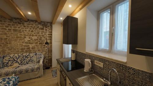 a kitchen with a sink and a window at Casa Blu in Šibenik