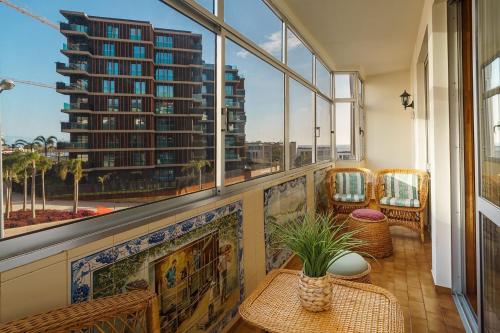 a balcony with a view of a tall building at GuestReady - Varanda de belas lembranças in Funchal