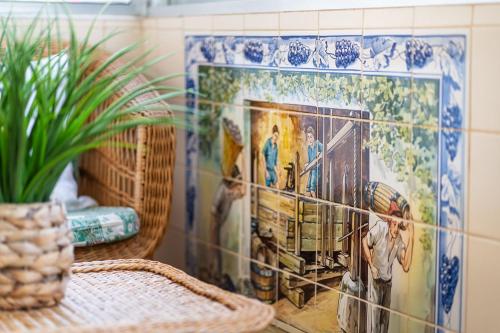 a mosaic tile wall with a painting on it at GuestReady - Varanda de belas lembranças in Funchal