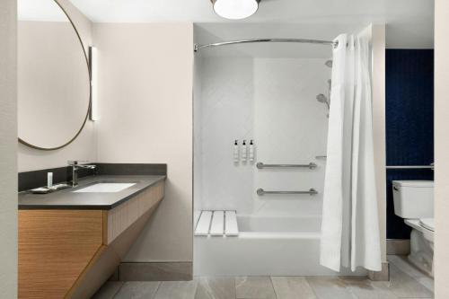a bathroom with a shower and a sink at Fairfield by Marriott Inn & Suites Charleston Downtown in Charleston