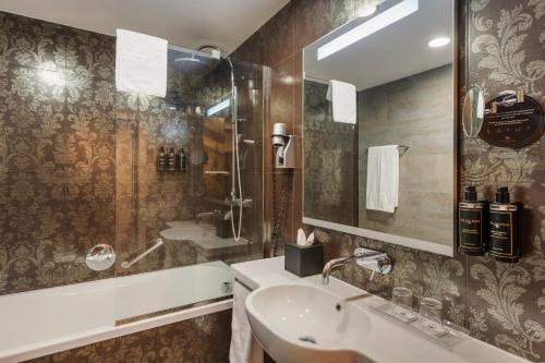 a bathroom with a sink and a mirror at Eurostars Palazzo Zichy in Budapest