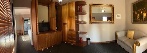 a living room with a couch and a mirror at Bohemian Guesthouse - Pretoria in Pretoria