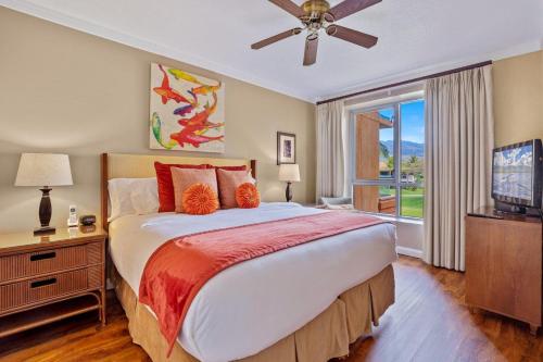 a bedroom with a large bed and a television at Honua Kai Konea 204 in Lahaina