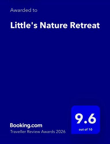 a blue screen with the wordsnature retreat on it at Little's Nature Retreat in Kartung