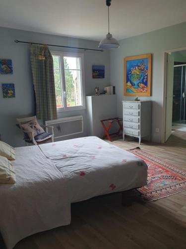 a bedroom with a large bed and a window at Chambre d'hôtes Le Luquet in Chazelles