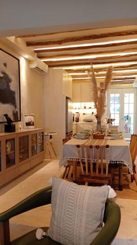 a living room with a dining table and a kitchen at Casa Rocka Boutique Breakfast & Beach Club included in Isla Mujeres