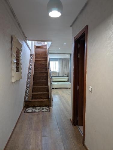 a hallway with a staircase with a couch in a room at Tanger City 5 in Tangier
