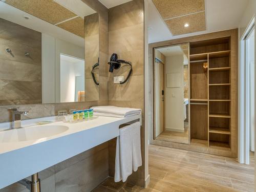 a bathroom with a sink and a large mirror at Playamojácar in Mojácar