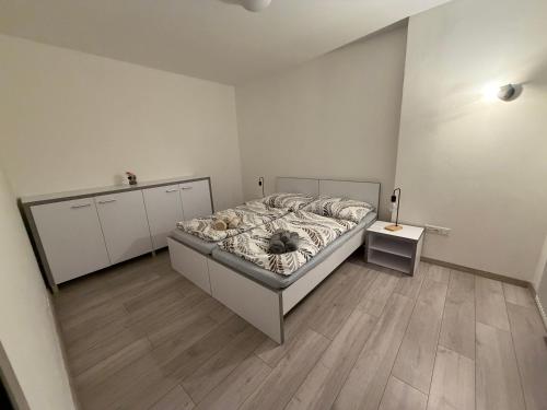 a bedroom with a bed and a wooden floor at Hradňanka Food&Beer in Predmier