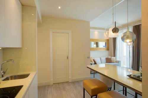 a kitchen with a counter and a table with chairs at Suite Milano Duomo in Milan