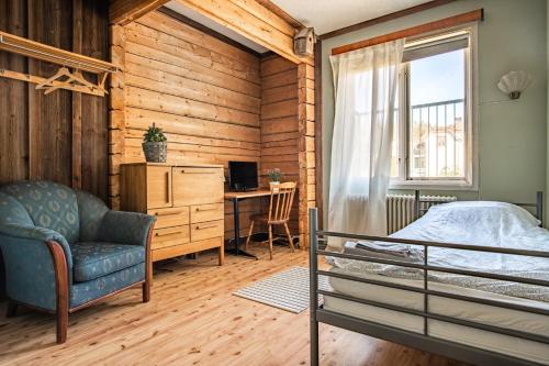 a bedroom with a bed and a desk and a chair at Wärdshuset Liden in Liden