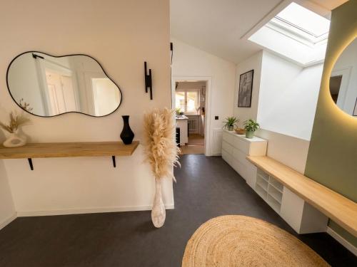 a bathroom with a mirror on the wall at Scandinavian Alpine Lodge nahe Tegernsee - stilvoll & ruhig in Reichersbeuern