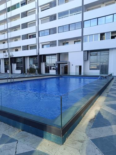 an empty swimming pool in front of a building at Tanger City 5 in Tangier