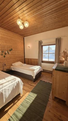 a large room with two beds and a window at Lumi Guest House in Arvidsjaur