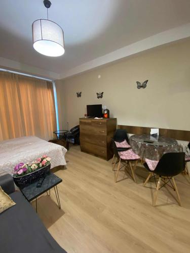 a bedroom with a bed and a table and chairs at studio in Itʼkhvisi
