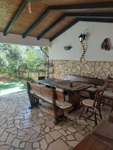 a patio with a wooden table and a bench at VisForYou Apartments in Vis