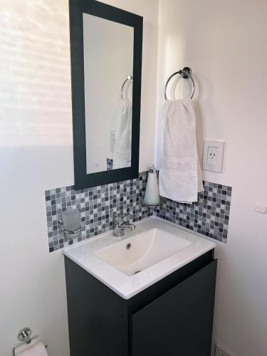 a bathroom with a sink and a mirror at Casa Cajita in Rancul