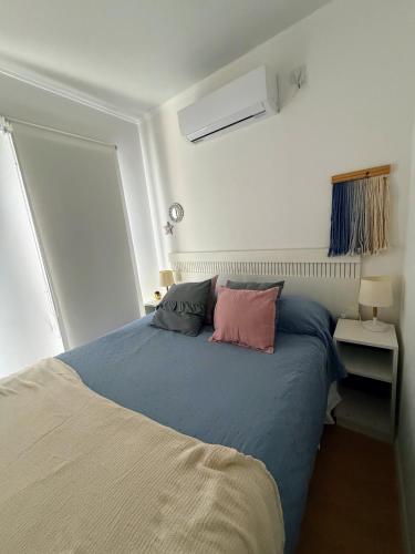 a bedroom with a bed with two pillows on it at Casa Cajita in Rancul
