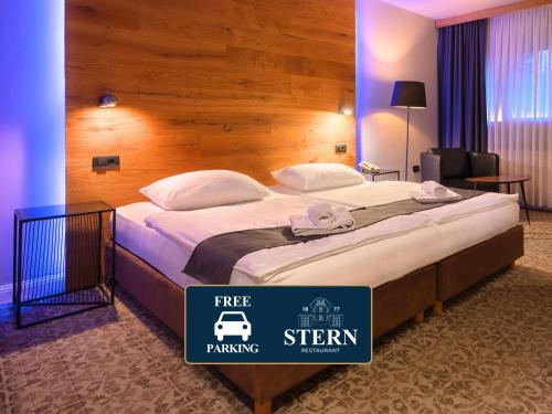 a bed in a hotel room with a sign that says free parking at Ljubljana Resort Hotel & Camping in Ljubljana