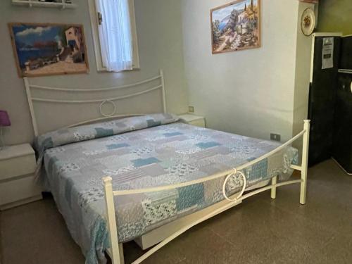 a bedroom with a bed with a white bed frame at Pisolo in Procchio