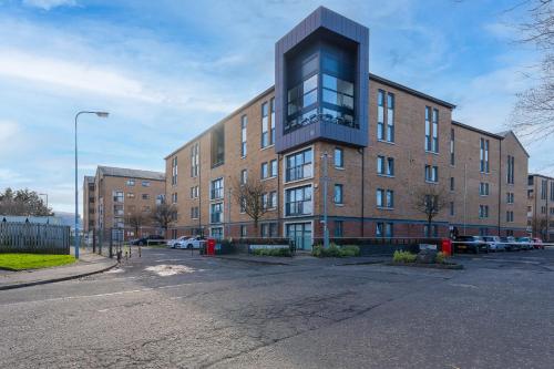 an empty parking lot in front of a brick building at The OVO Hydro Penthouse With Free Parking in Glasgow