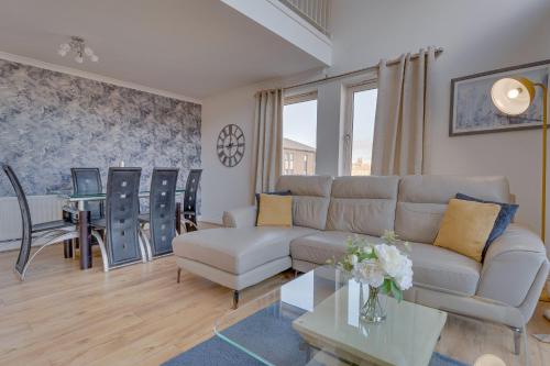 a living room with a couch and a table at The OVO Hydro Penthouse With Free Parking in Glasgow