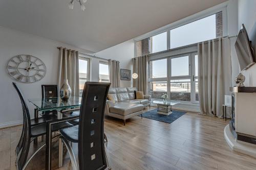 a living room with a couch and a table at The OVO Hydro Penthouse With Free Parking in Glasgow
