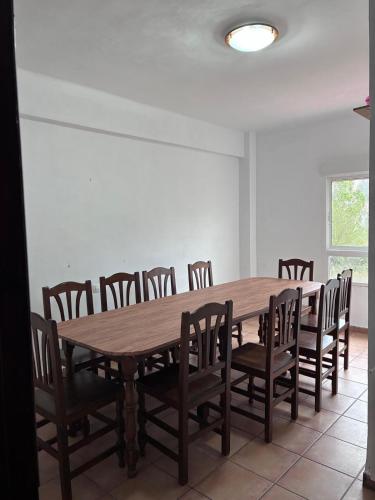 a dining room with a wooden table and chairs at Hotel Move Espadan in Azuébar