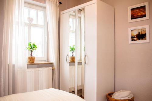 a bedroom with a white door and a window at Strandstr 4b "Likedeeler 2" in Zingst