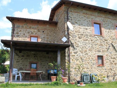 an external view of a stone house with a table and chairs at Holiday Home in Mulazzo near Tuscan Castles in Mulazzo