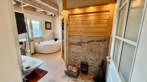 a bathroom with a tub and a sink and a bath tub at Penthouse Meeresrauschen in Dierhagen