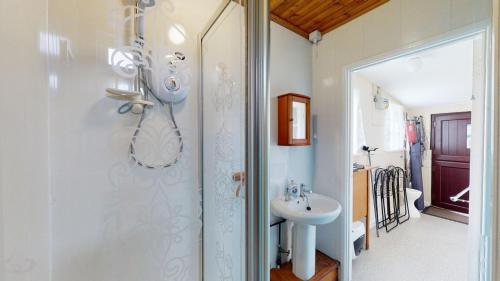 a bathroom with a shower and a sink at C19 Old Range, Riviere Towans in Hayle